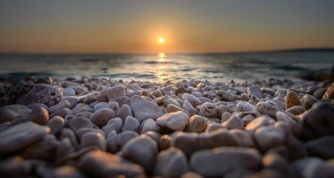 Beach pebbles at sunset, close up macro Stock Photos