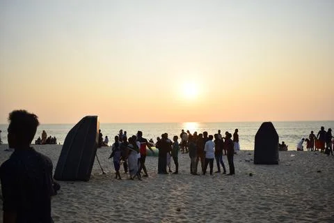 A beach with people in the evening time Stock Photos