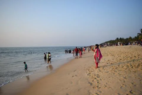 A beach with people in the evening time Stock Photos