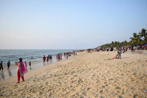 A beach with people in the evening time Stock Photos
