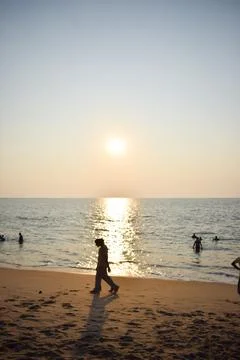 A beach with people in the evening time Stock Photos