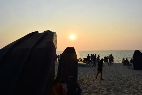 A beach with people in the evening time Stock Photos
