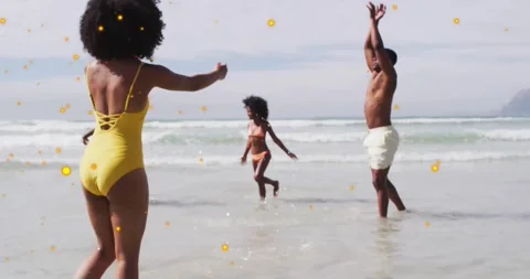 On beach, people experiencing animation with glowing particles floating in air Stock Footage 328150815