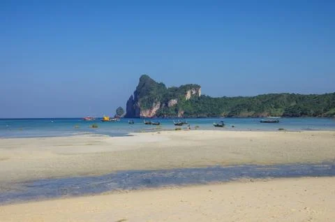 Beach of Phi Phi island in low tide with bay and longboat on background, Krab Stock Photos