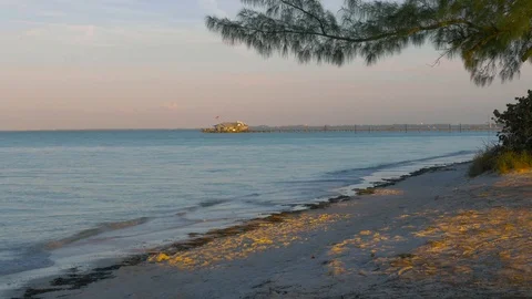 Beach Pier Leading to Building at Sunset, 4K Stock Footage 70813710