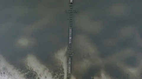 Beach pier were damaged by a hurricane that brought strong winds and heavy Stock Footage 165372984