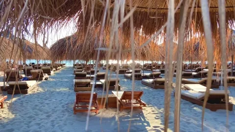 The beach is pierced by the rays of the setting sun. Stock Footage 247082137