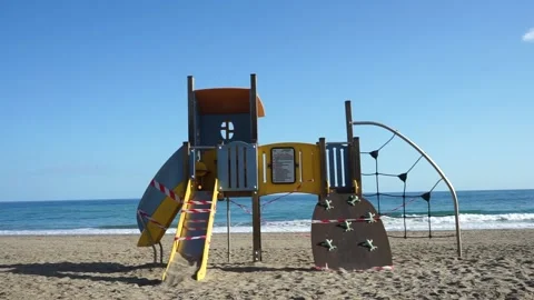 Beach playground taped closed because of Covid 19 Stock Footage 146306568