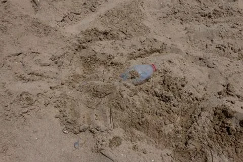 Beach pollution and garbage in Mediterranean Sea .Used dirty plastic bottle. Stock Photos