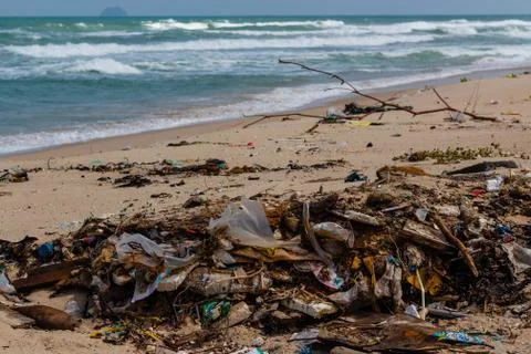 Beach pollution, plastic and waste from ocean on the beach Stock Photos