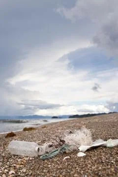 Beach pollution. Plastic bottles and other trash on sea beach. Ocean pollutio Stock Photos