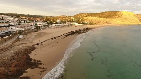 Beach of Praia da Luz at sunset, Lagos, Algarve, Portugal aerial view Stock Footage 72289046