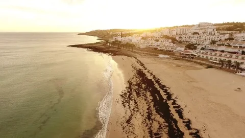 Beach of Praia da Luz at sunset, Lagos, Algarve, Portugal aerial view 스톡 동영상 72289175