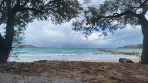 A beach with a rainbow and a stormy sky. blue ocean Stock Footage 264063115