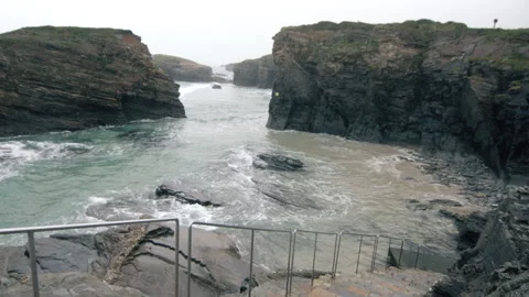 Beach on a rainy grey winter day, high tide sea. 스톡 동영상 169748516