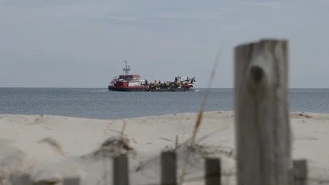 Beach Replenishment Hopper Dredger Ship with Dune Fence in Foreground Stock Footage 102747428