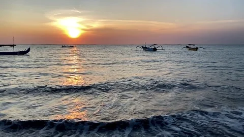 Beach resort during sunset late afternoon or early evening with some boats Stock Footage 241140974
