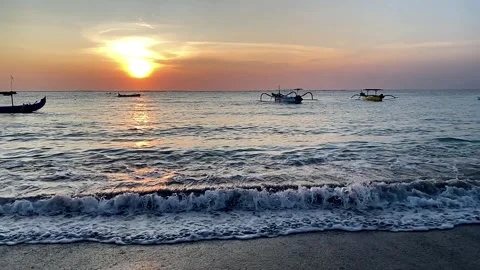 Beach resort during sunset late afternoon or early evening with some boats Stock Footage 241140976