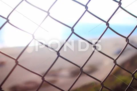 Beach Resort Sunlight and wire fence in Malibu California USA Stock Photos