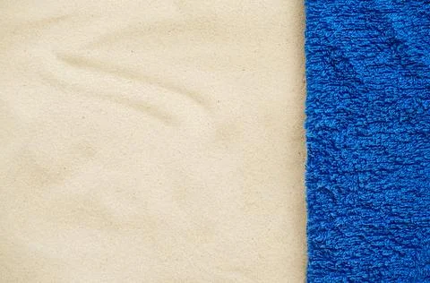Beach resort theme background, texture. Blue towel on the sand. Stock Photos