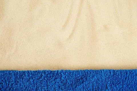Beach resort theme background, texture. Blue towel on the sand. Stock Photos