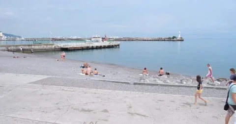 Beach of the resort town in cloudy weather with a few vacationers Stock Footage 207010152