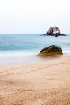 Beach with rock vertical Stock Photos