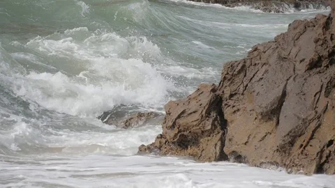 Beach rock waves during storm slow motion Stock-Footage 75656072