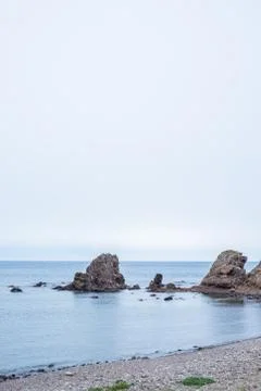 Beach with rocks in the background 스톡 사진