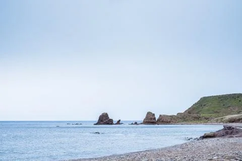 Beach with rocks in the background 스톡 사진