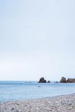 Beach with rocks in the background 스톡 사진