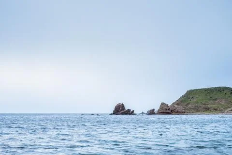 Beach with rocks in the background 스톡 사진