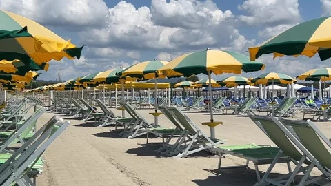 Beach with rows of colorful umbrellas and sunbeds on beach in Versilia Tuscany Stockbeeldmateriaal 340030105