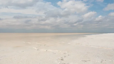 The beach of the salt lake with clouds reflected in the smooth water. Stock Footage 108208193