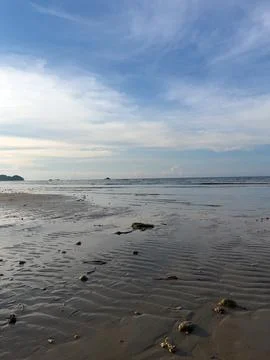 Beach Sand and Ocean Under Blue Sky 写真素材