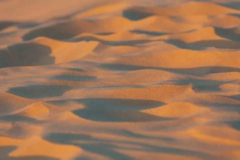 Beach sand closeup at sunset Stock Photos