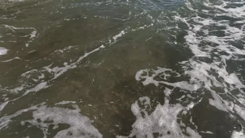 Beach sand hit by foaming waves Stock Footage 319807062