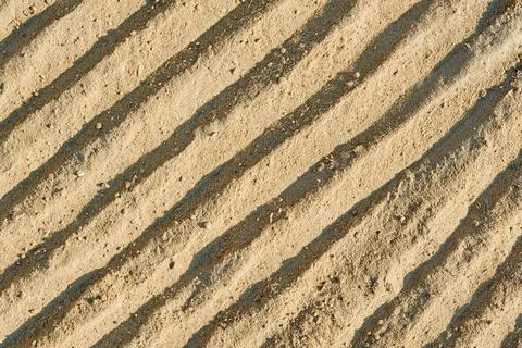 Beach sand pattern as background with natural wave. Natural sand beach sand t Stock Photos