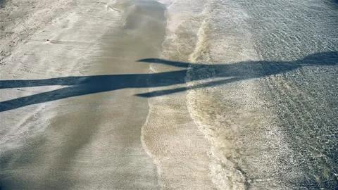 Beach sand shadow walking slow motion Stock Footage 240639844