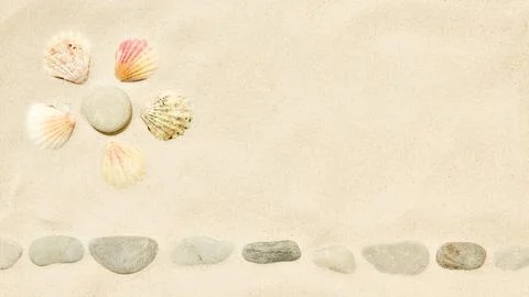 Beach sand with Sun symbol of seashells and pebbles Stock Photos