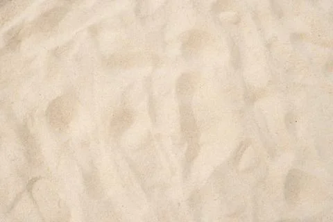 Beach sand of texture as background. Wallpaper and background concept. Stock Photos