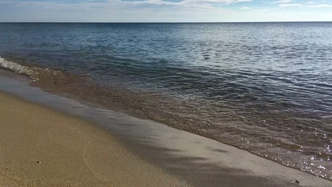 Beach, sand, waves and open sea during sunrise. MJPEG codec Stock Footage 81095408