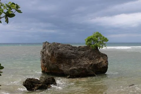Beach with sand, waves, sky and rock 스톡 사진