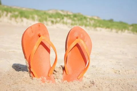 BEACH SANDALS IN SAND Stock Photos