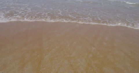 Beach sands at the coast with ocean waves rolling over Stock Footage 150640666