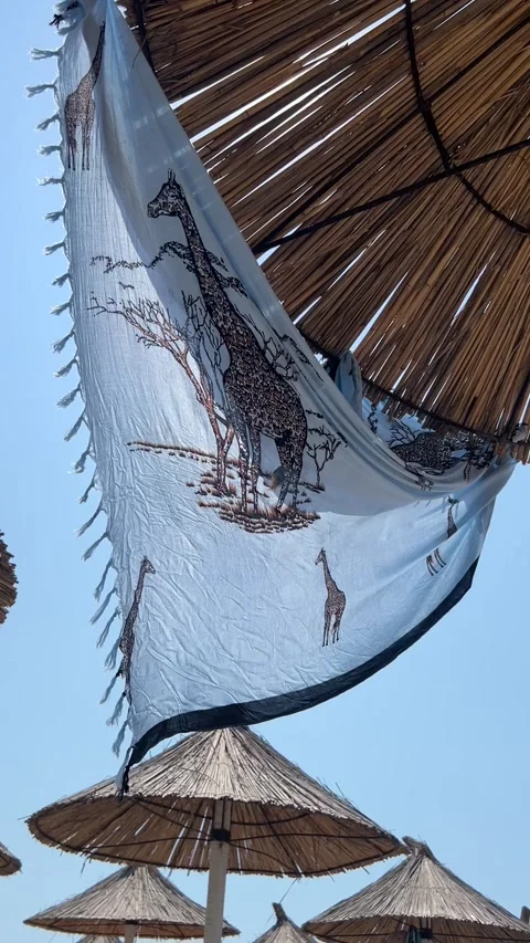Beach Sarong with Giraffe Pattern Waving Under Straw Umbrella in Golem, Albania Видео 343391644