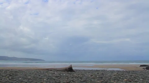 Beach Scene Cloudy Sky TimeLapse Pebbles and Sand Stock Footage 26554982