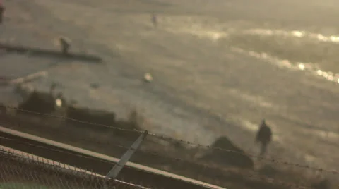 Beach Scene at Dusk with Focus Pull from Barbed Wire Fence Video stock 25134959
