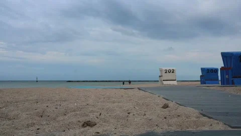 Beach scene in Germany with sand, beach chairs, and people walking along th.. Stock Footage 340195318
