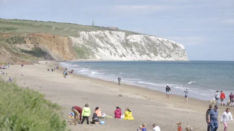 A beach scene with a large crowd of people enjoying the day Stock Footage 298259634